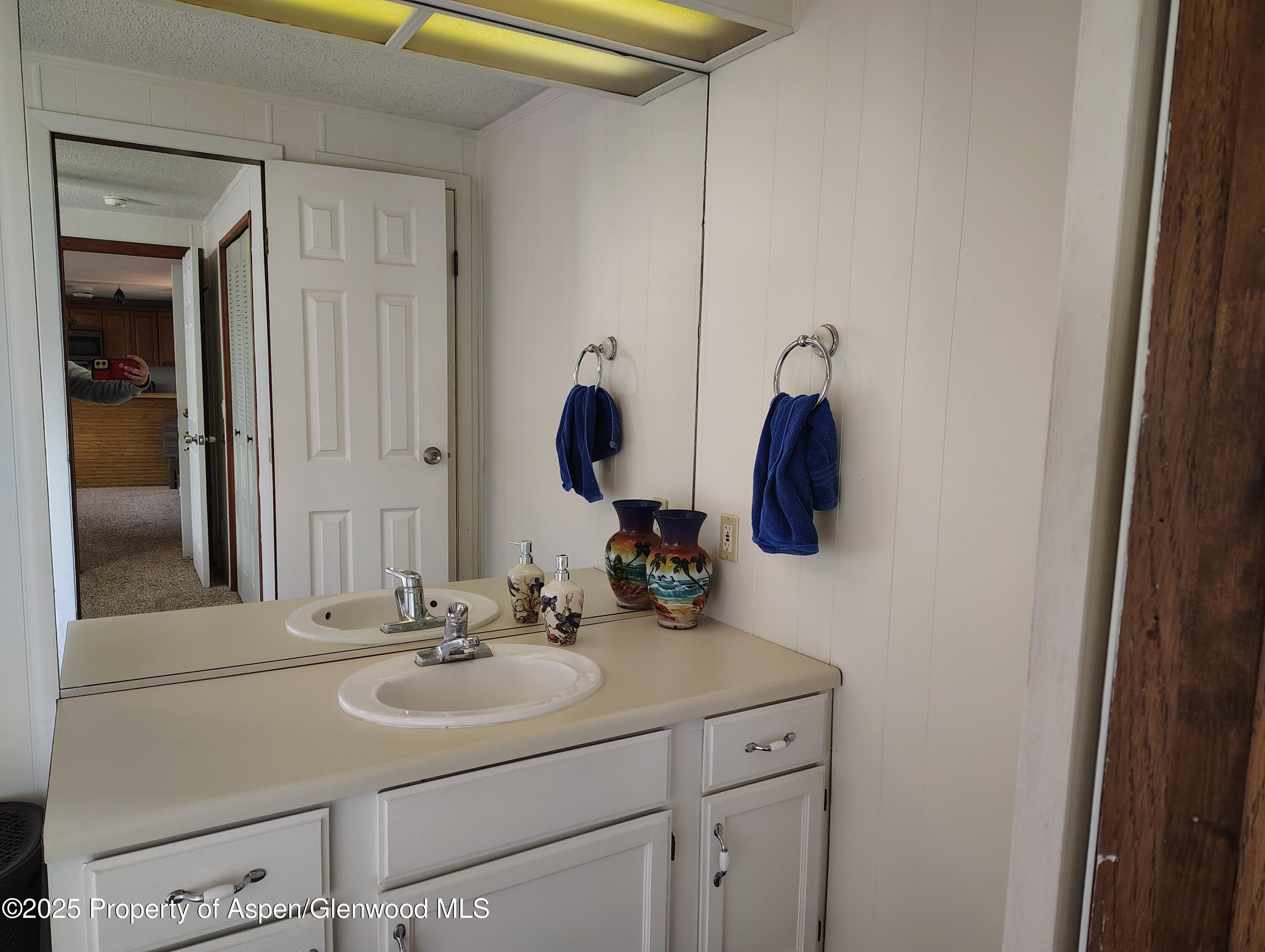 8 St John Circle Parachute, CO 81635 - Photo 17 of 32 a bathroom with a sink and a mirror