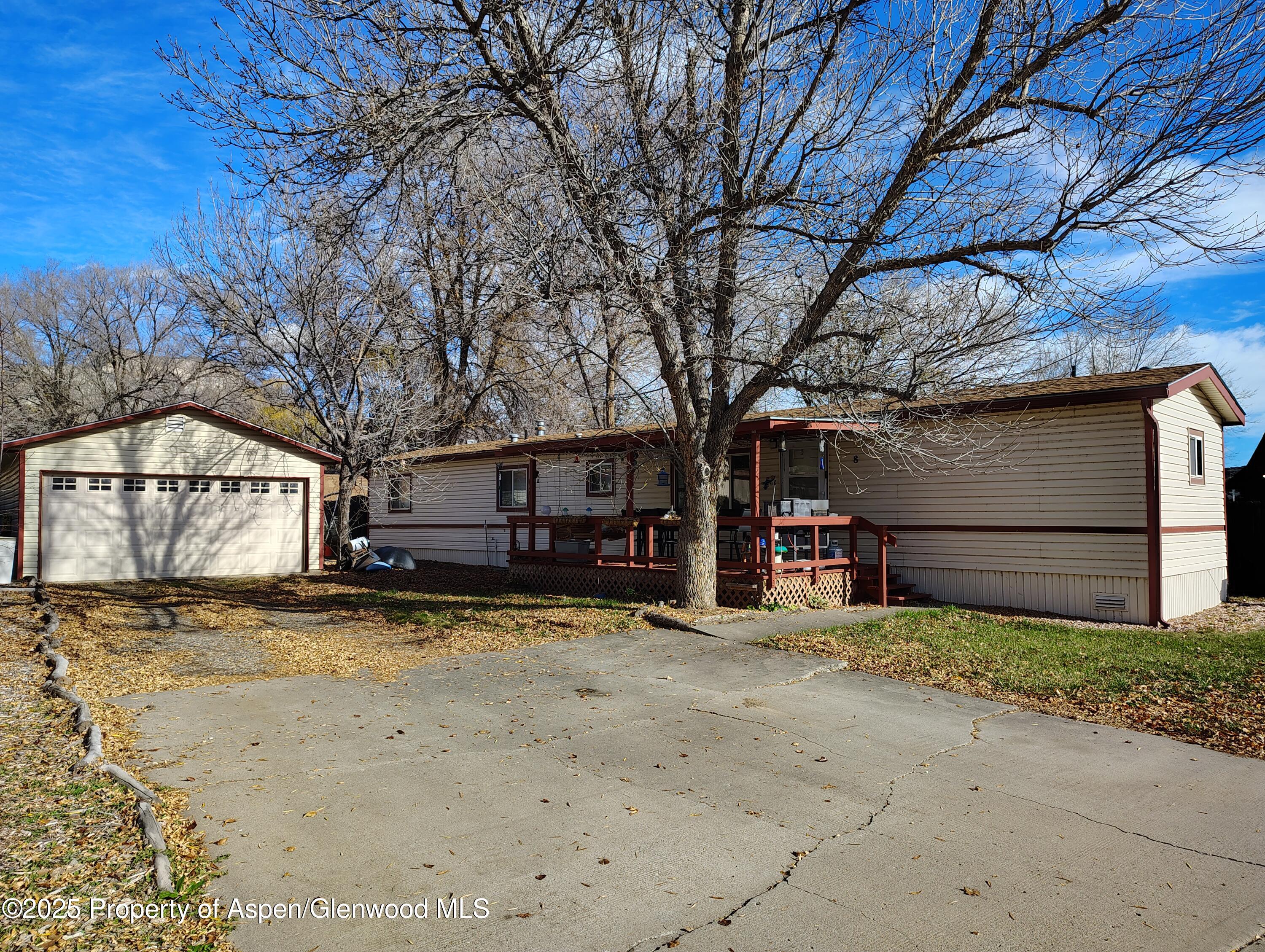 8 St John Circle Parachute, CO 81635 - Photo 2 of 32 a view of a house with large tree and wooden fence
