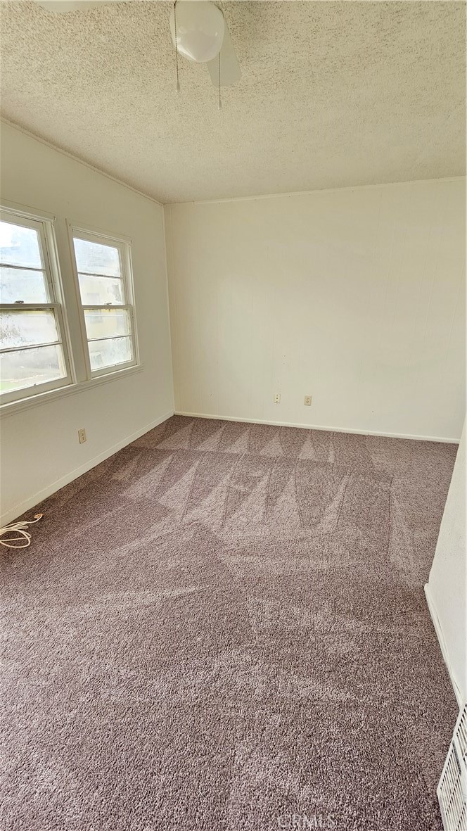 1410 Canyon Road San Bernardino, CA 92404 - Photo 4 of 6 an empty room with windows