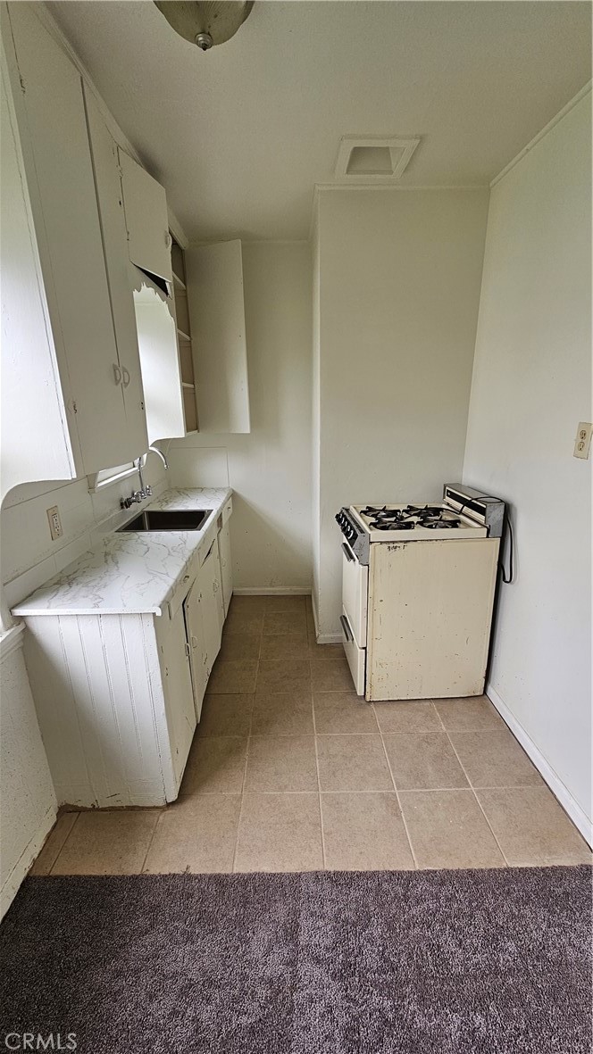 1410 Canyon Road San Bernardino, CA 92404 - Photo 5 of 6 a view of a kitchen with furniture and a rug