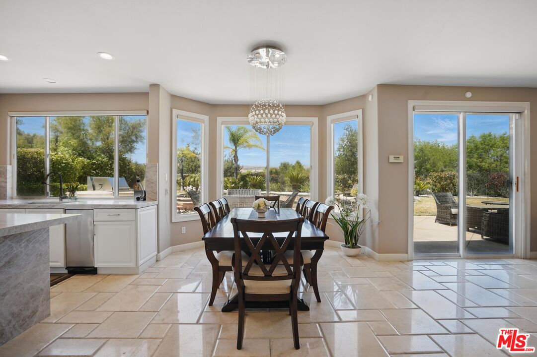 4040 Leighton Point Road Calabasas, CA 91301 - Photo 15 of 47 a dining room with furniture and large windows