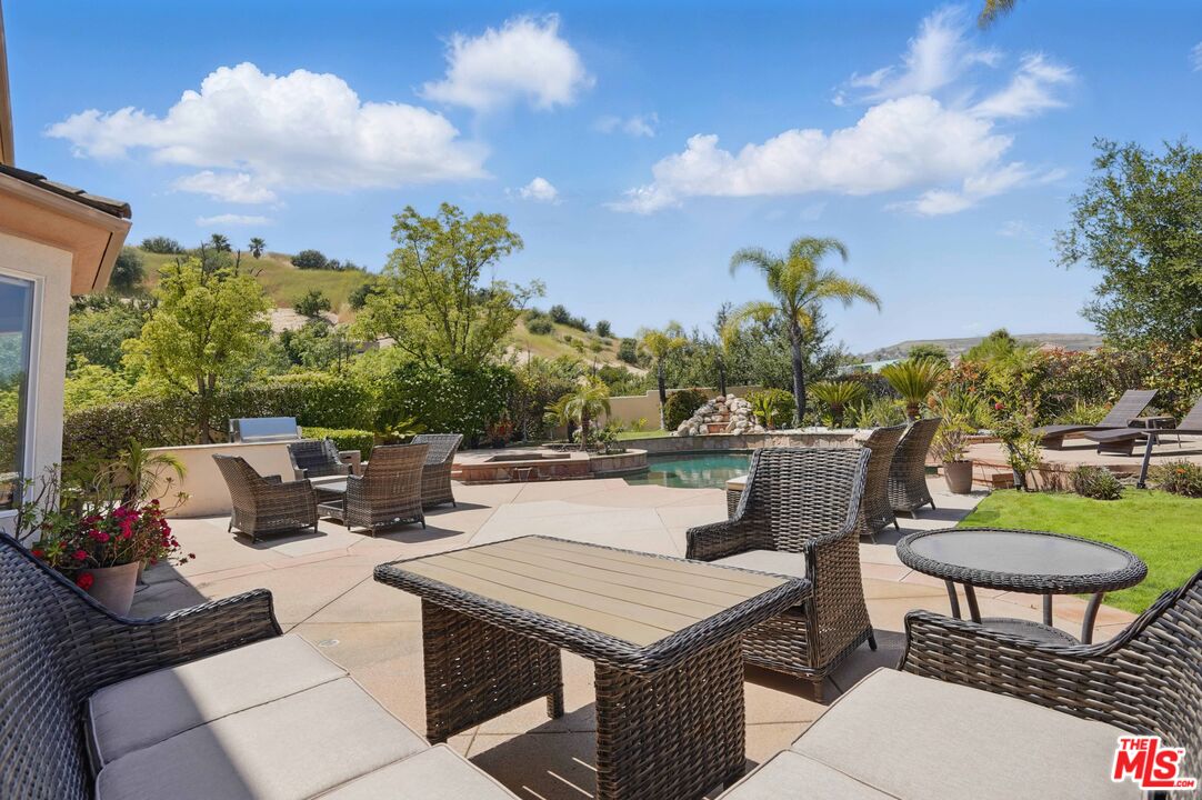 4040 Leighton Point Road Calabasas, CA 91301 - Photo 18 of 47 a view of a patio with couches chairs and a potted plant
