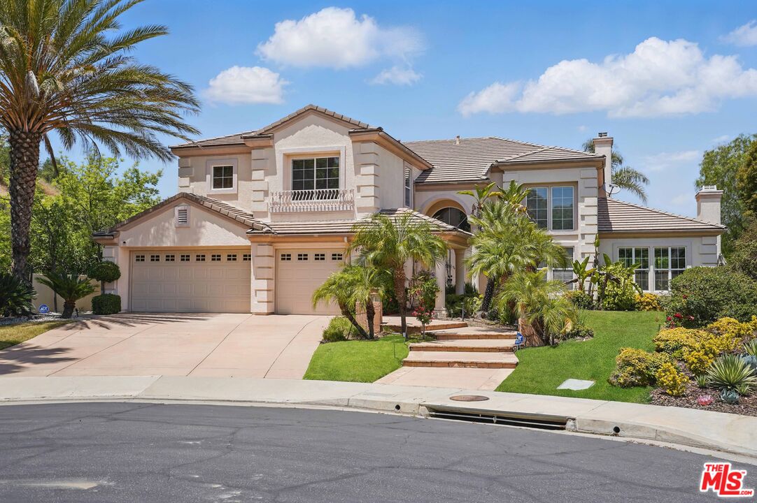 4040 Leighton Point Road Calabasas, CA 91301 - Photo 2 of 47 a front view of a house with a garden and trees
