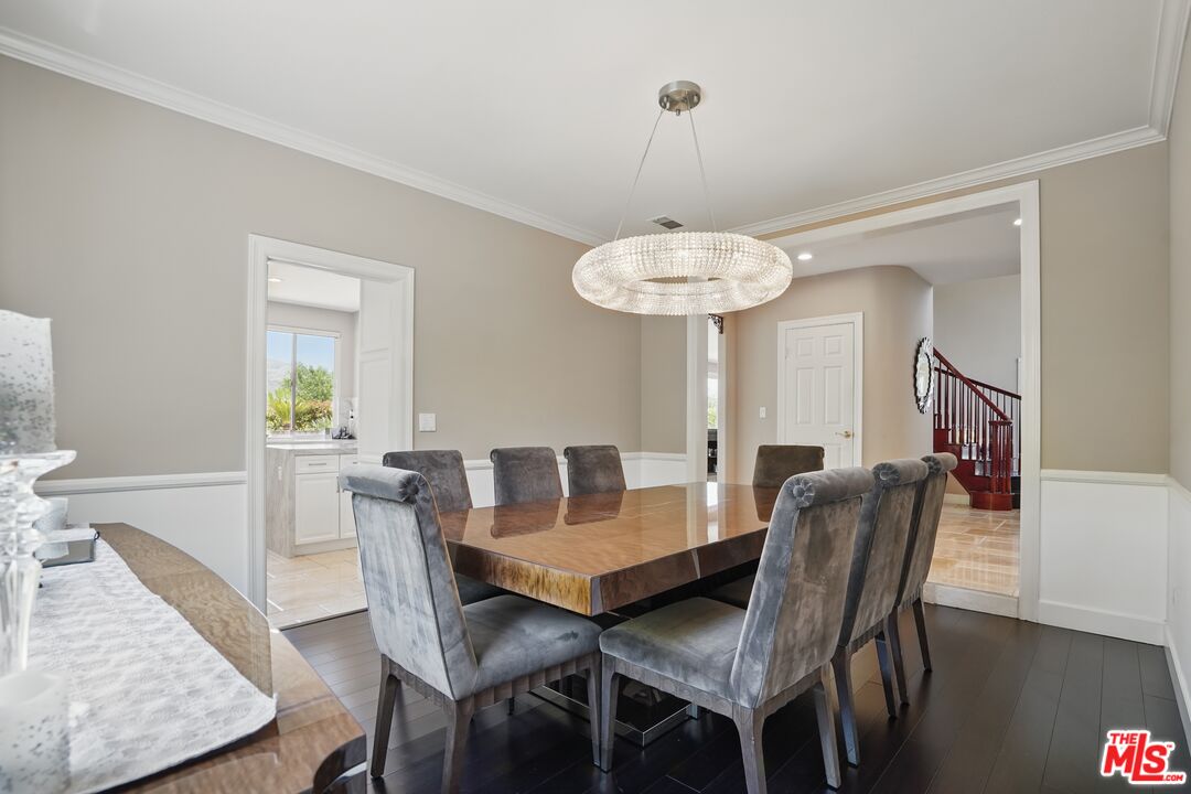 4040 Leighton Point Road Calabasas, CA 91301 - Photo 26 of 47 a view of a dining room and livingroom with furniture wooden floor a chandelier