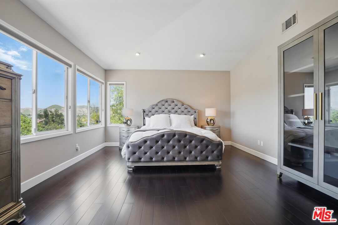 4040 Leighton Point Road Calabasas, CA 91301 - Photo 30 of 47 a bedroom with a bed and window