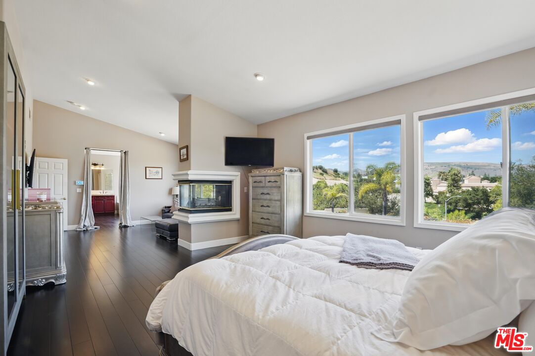 4040 Leighton Point Road Calabasas, CA 91301 - Photo 32 of 47 a spacious bedroom with a large bed and a large window