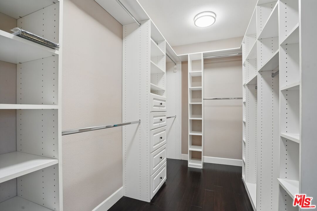 4040 Leighton Point Road Calabasas, CA 91301 - Photo 33 of 47 a view of walk in closet with empty racks
