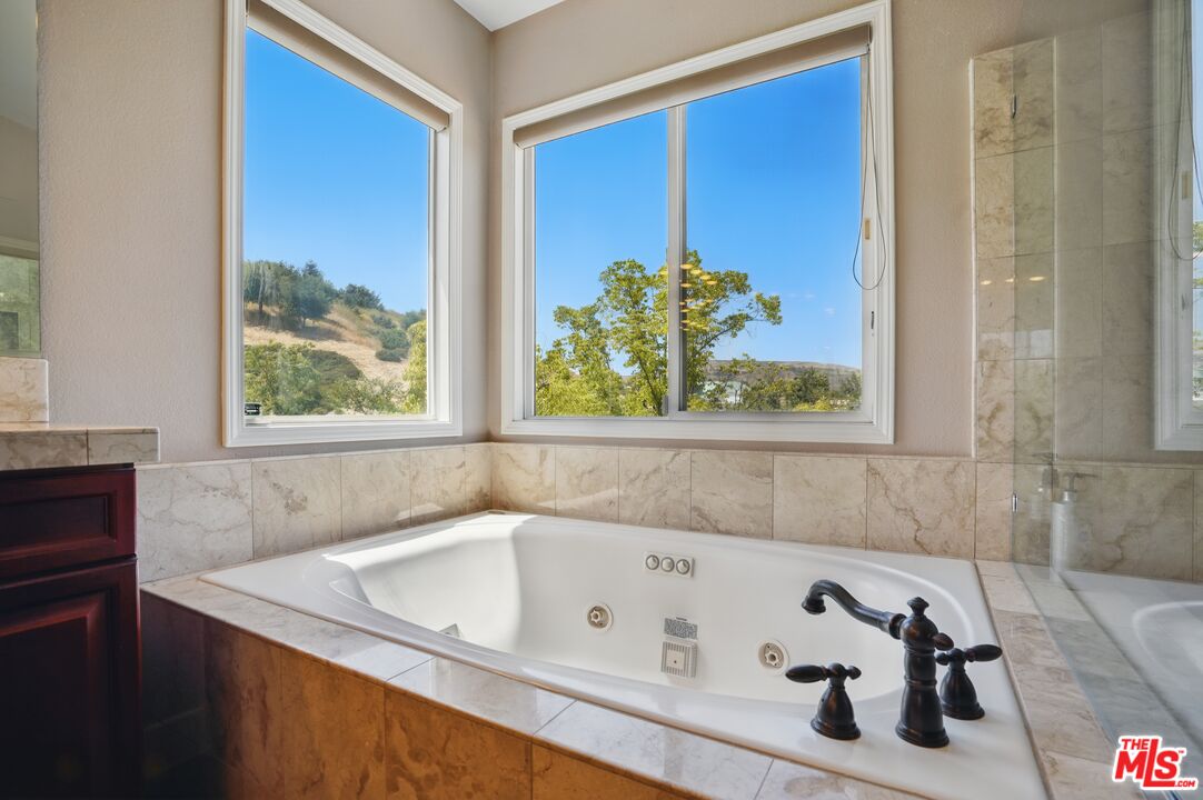 4040 Leighton Point Road Calabasas, CA 91301 - Photo 37 of 47 a bathroom with a tub sink and window