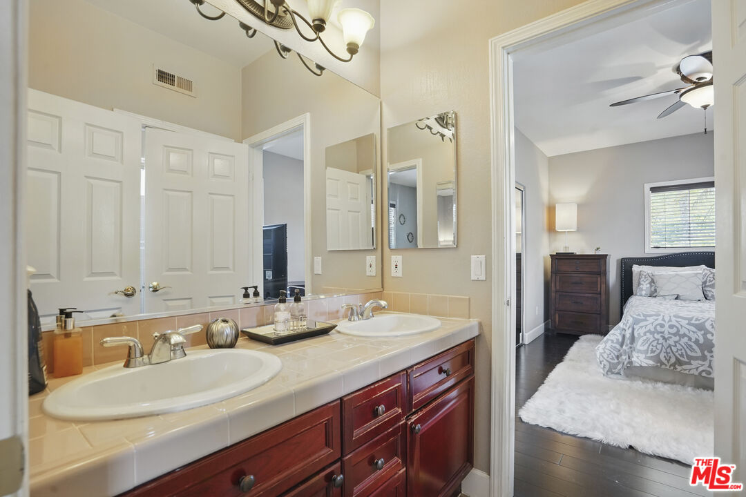 4040 Leighton Point Road Calabasas, CA 91301 - Photo 39 of 47 a bathroom with a sink double vanity and a mirror