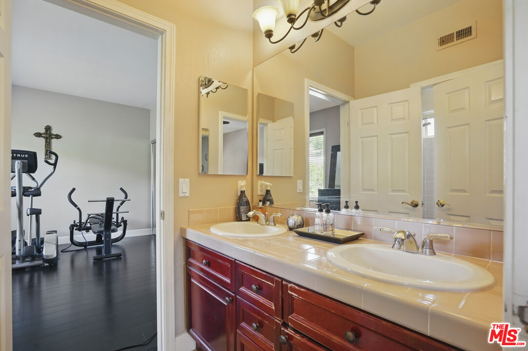 4040 Leighton Point Road Calabasas, CA 91301 - Photo 42 of 47 a bathroom with a sink and a mirror