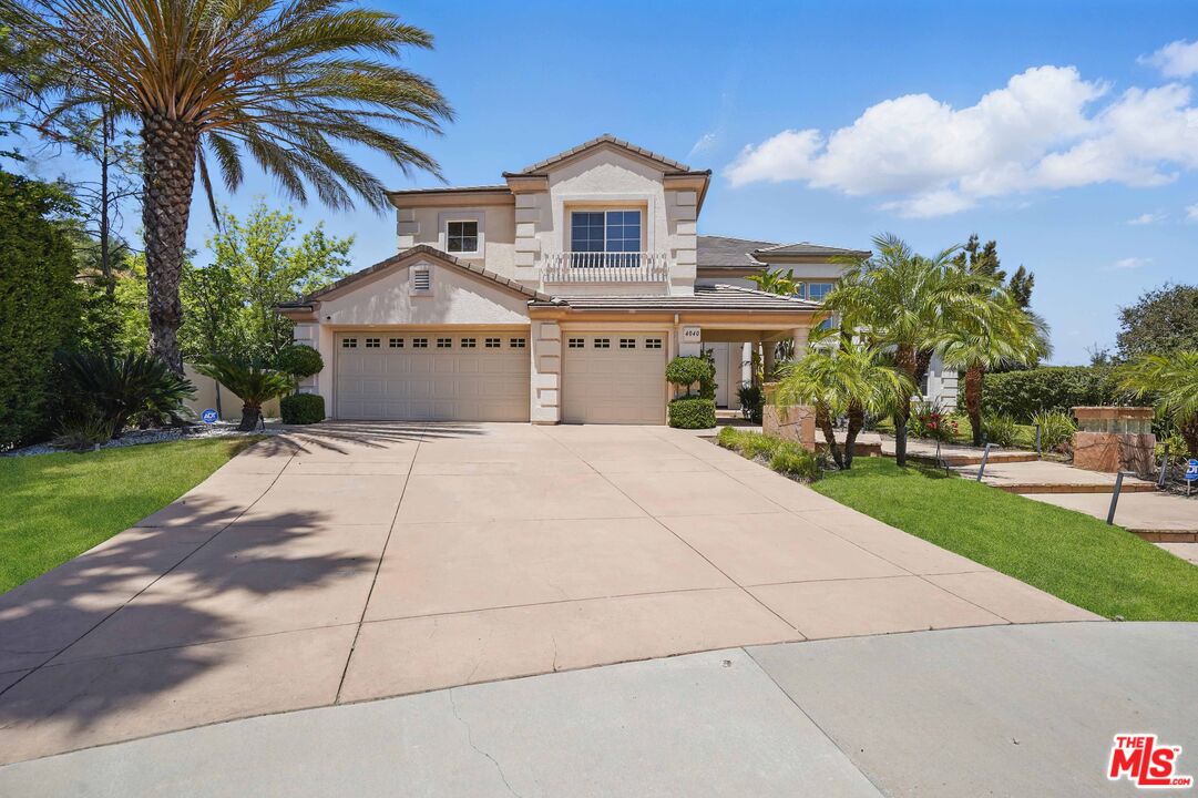 4040 Leighton Point Road Calabasas, CA 91301 - Photo 8 of 47 a front view of a house with a garden