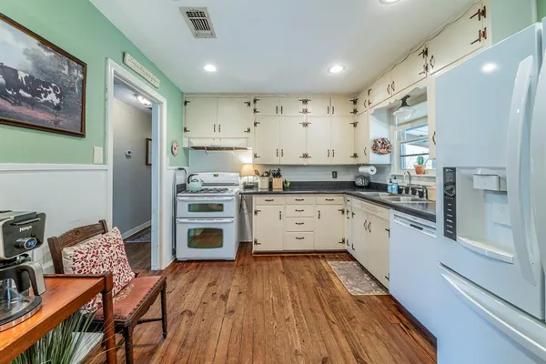 a kitchen with a refrigerator and a stove