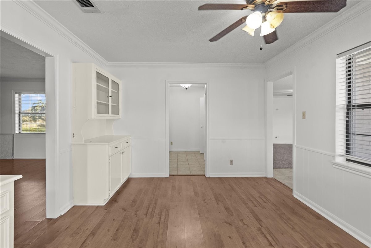 105 Alice Street Anahuac, TX 77514 - Photo 11 of 39 wooden floor in an empty room with a window