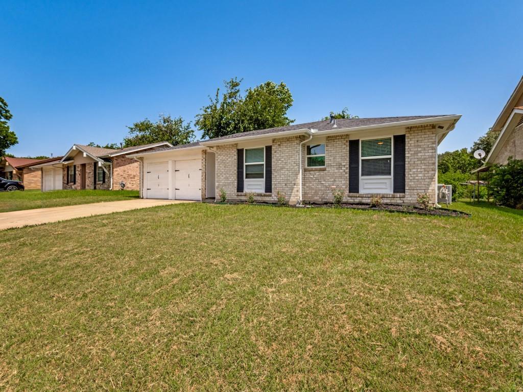1405 Rambler Road Arlington, TX 76014 - Photo 3 of 26 Brick exterior with dark shutters, dual garage doors, and a concrete driveway
