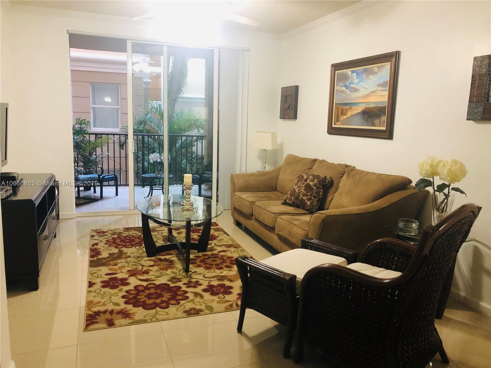 17100 North Bay Road, Unit 1212 Sunny Isles Beach, FL 33160 - Photo 1 of 24 a living room with furniture and a floor to ceiling window