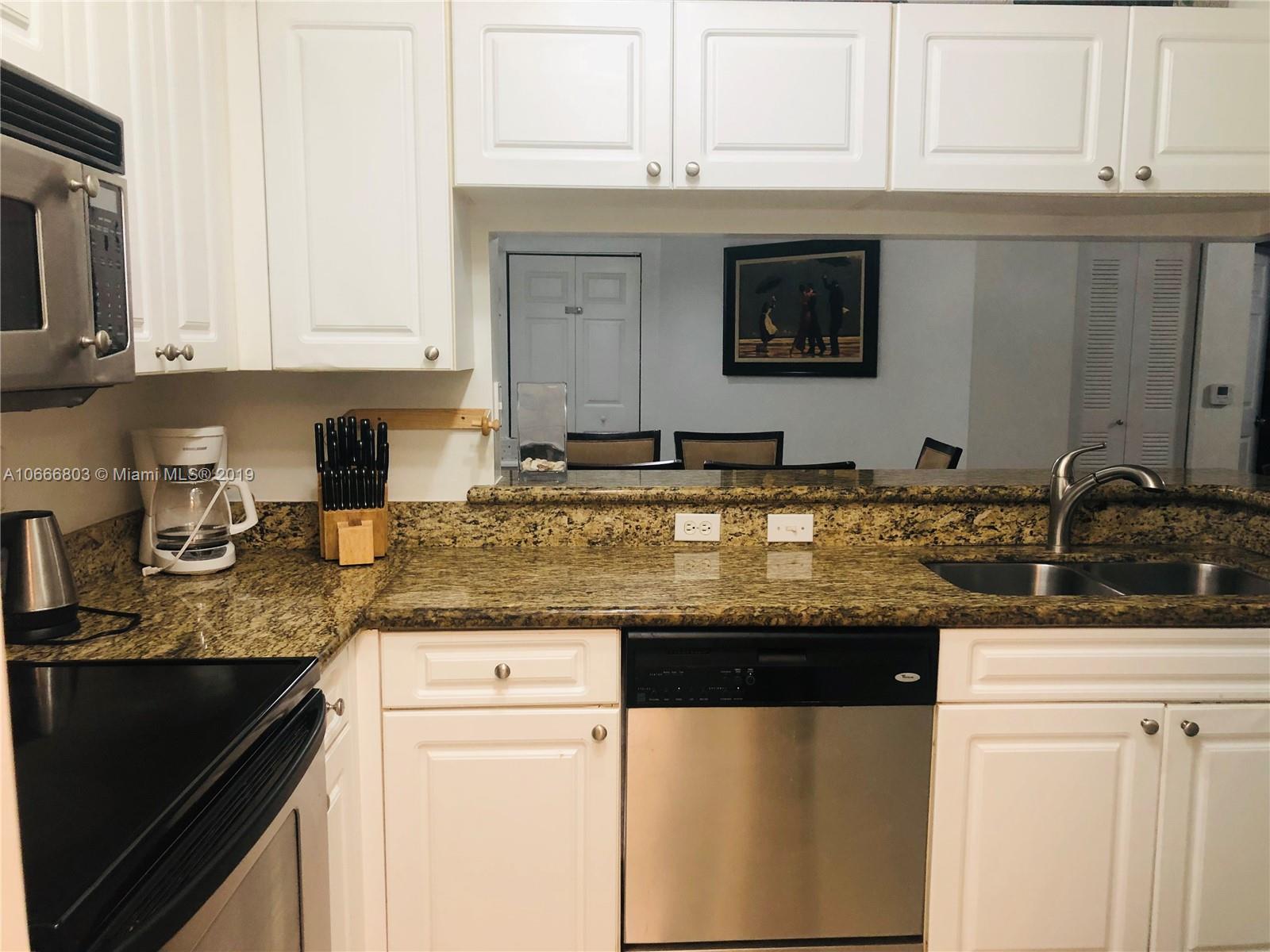 17100 North Bay Road, Unit 1212 Sunny Isles Beach, FL 33160 - Photo 13 of 24 a kitchen with granite countertop a sink and a stove