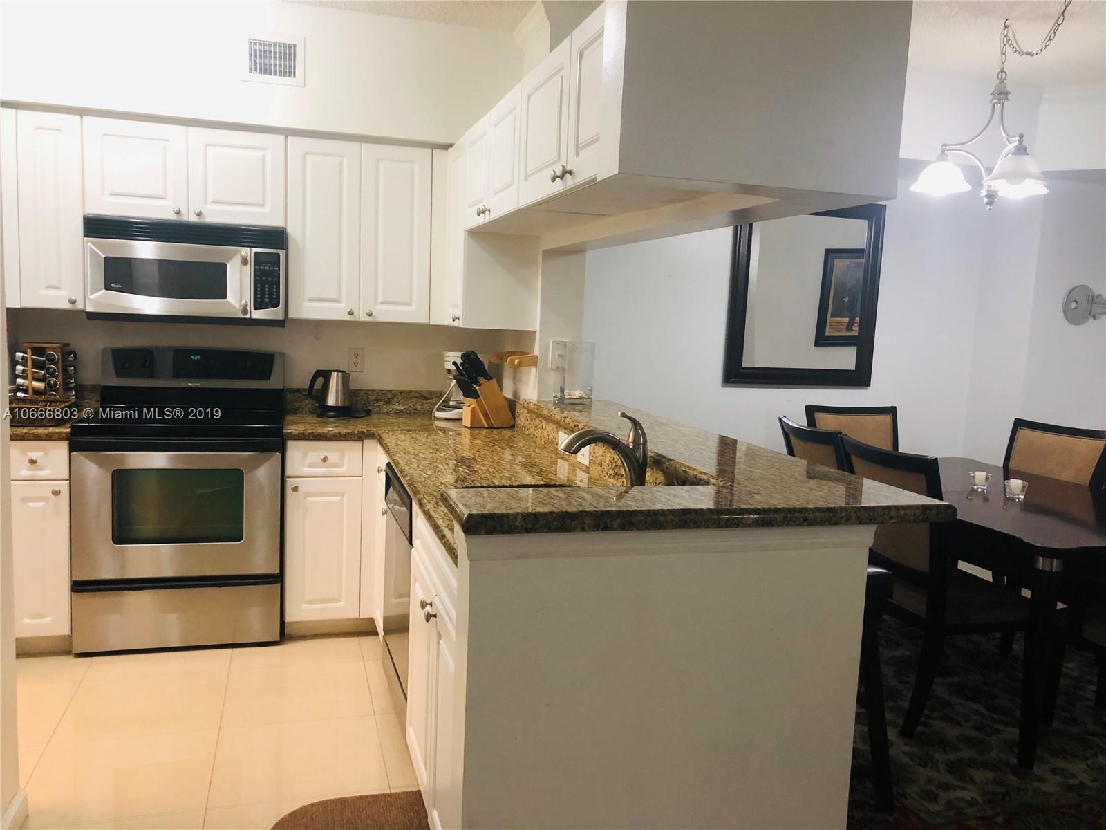 17100 North Bay Road, Unit 1212 Sunny Isles Beach, FL 33160 - Photo 15 of 24 a kitchen with stainless steel appliances a stove sink and microwave