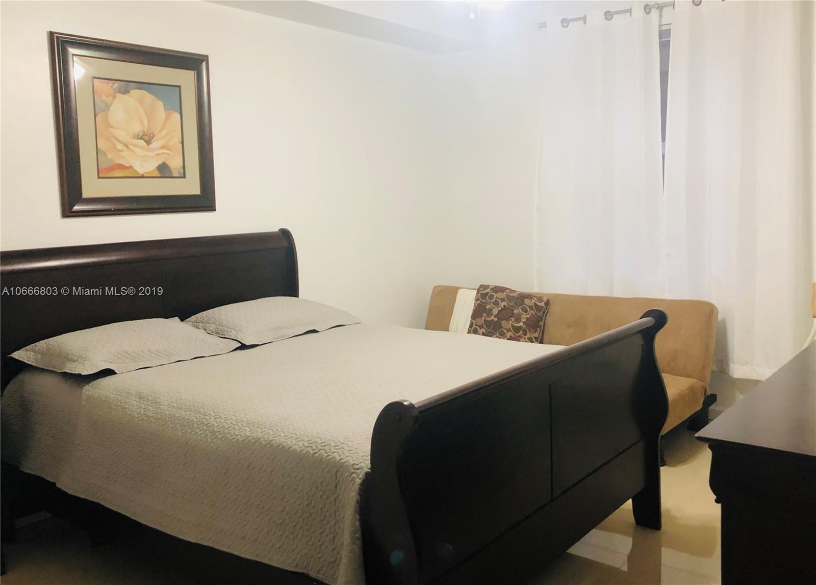 17100 North Bay Road, Unit 1212 Sunny Isles Beach, FL 33160 - Photo 16 of 24 a bedroom with a bed and painting on the wall