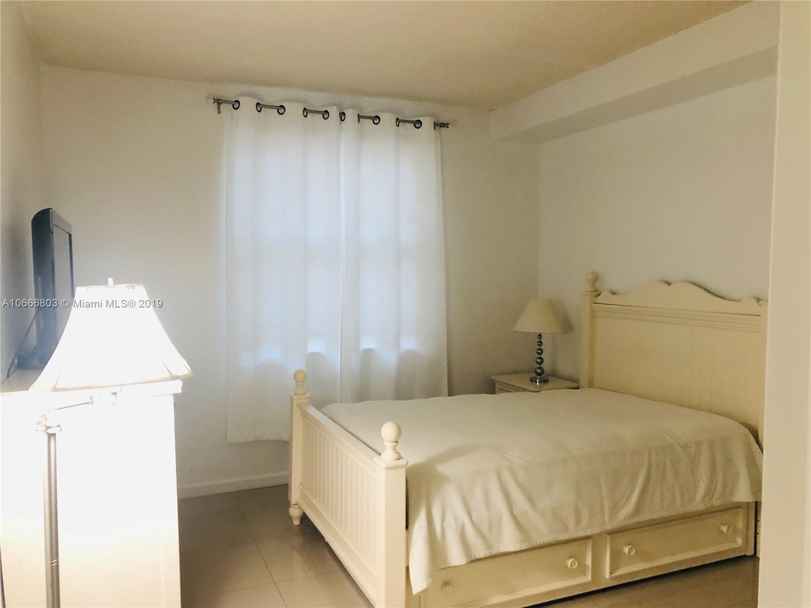 17100 North Bay Road, Unit 1212 Sunny Isles Beach, FL 33160 - Photo 17 of 24 a bedroom with a bed and a dresser