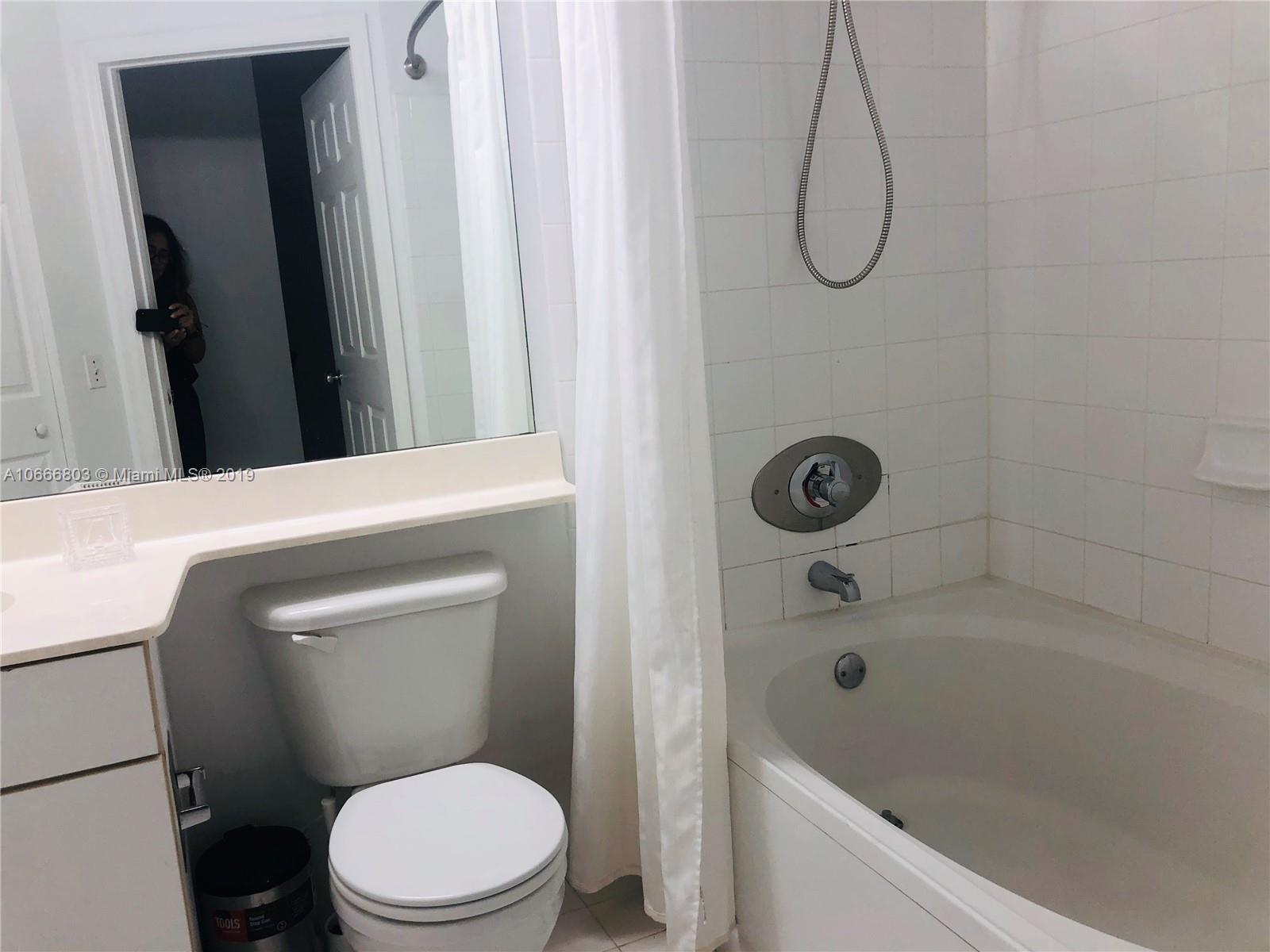 17100 North Bay Road, Unit 1212 Sunny Isles Beach, FL 33160 - Photo 19 of 24 a bathroom with a sink a toilet and shower