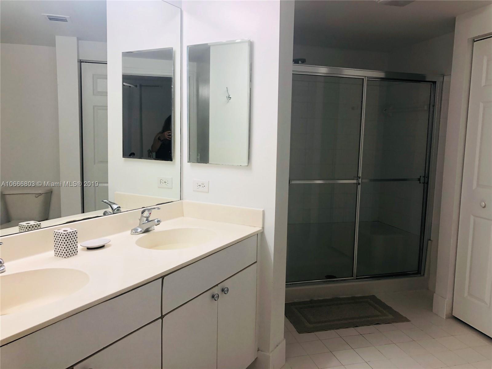 17100 North Bay Road, Unit 1212 Sunny Isles Beach, FL 33160 - Photo 21 of 24 a bathroom with a sink and a mirror