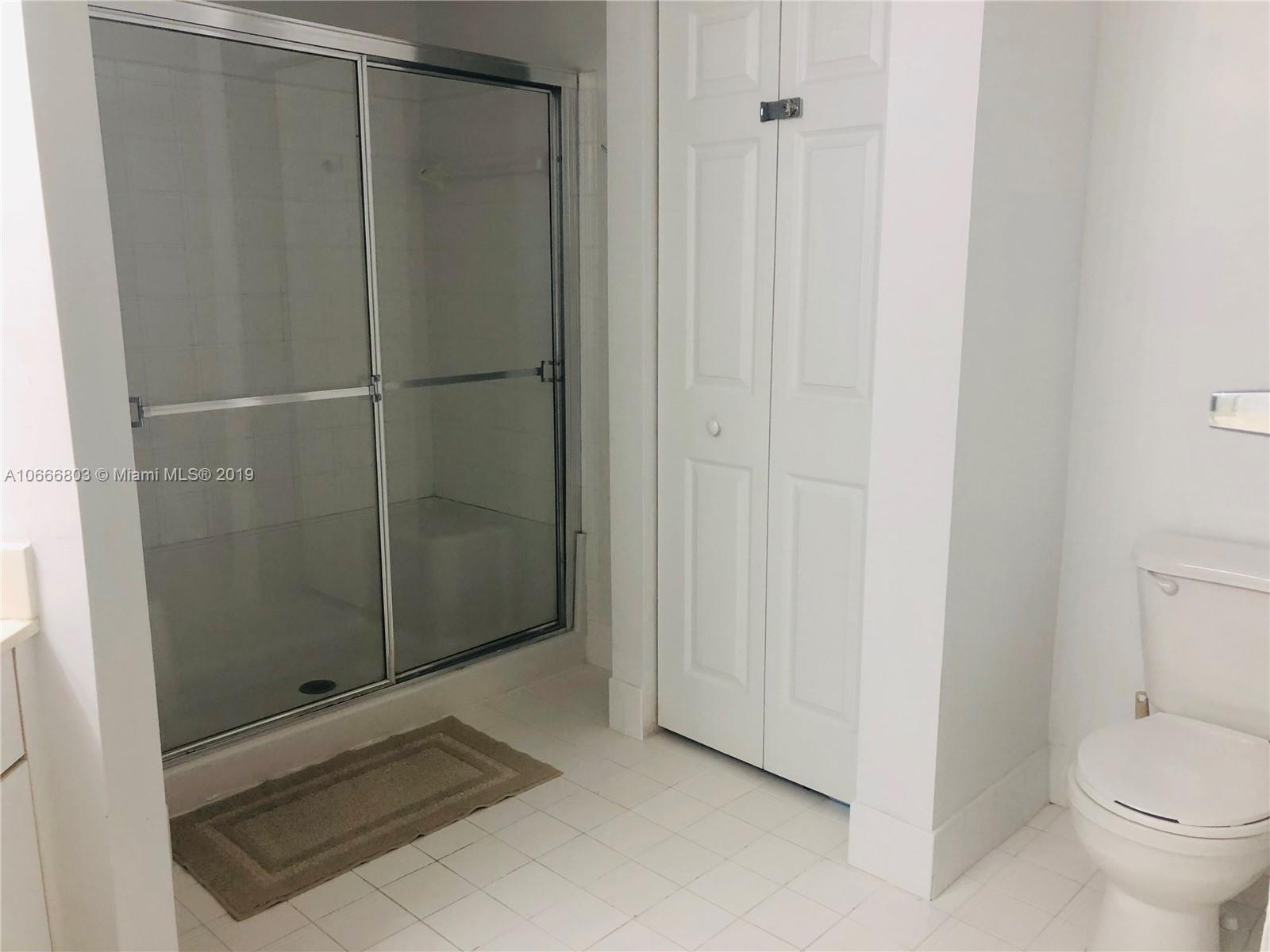 17100 North Bay Road, Unit 1212 Sunny Isles Beach, FL 33160 - Photo 22 of 24 a bathroom with a glass shower door