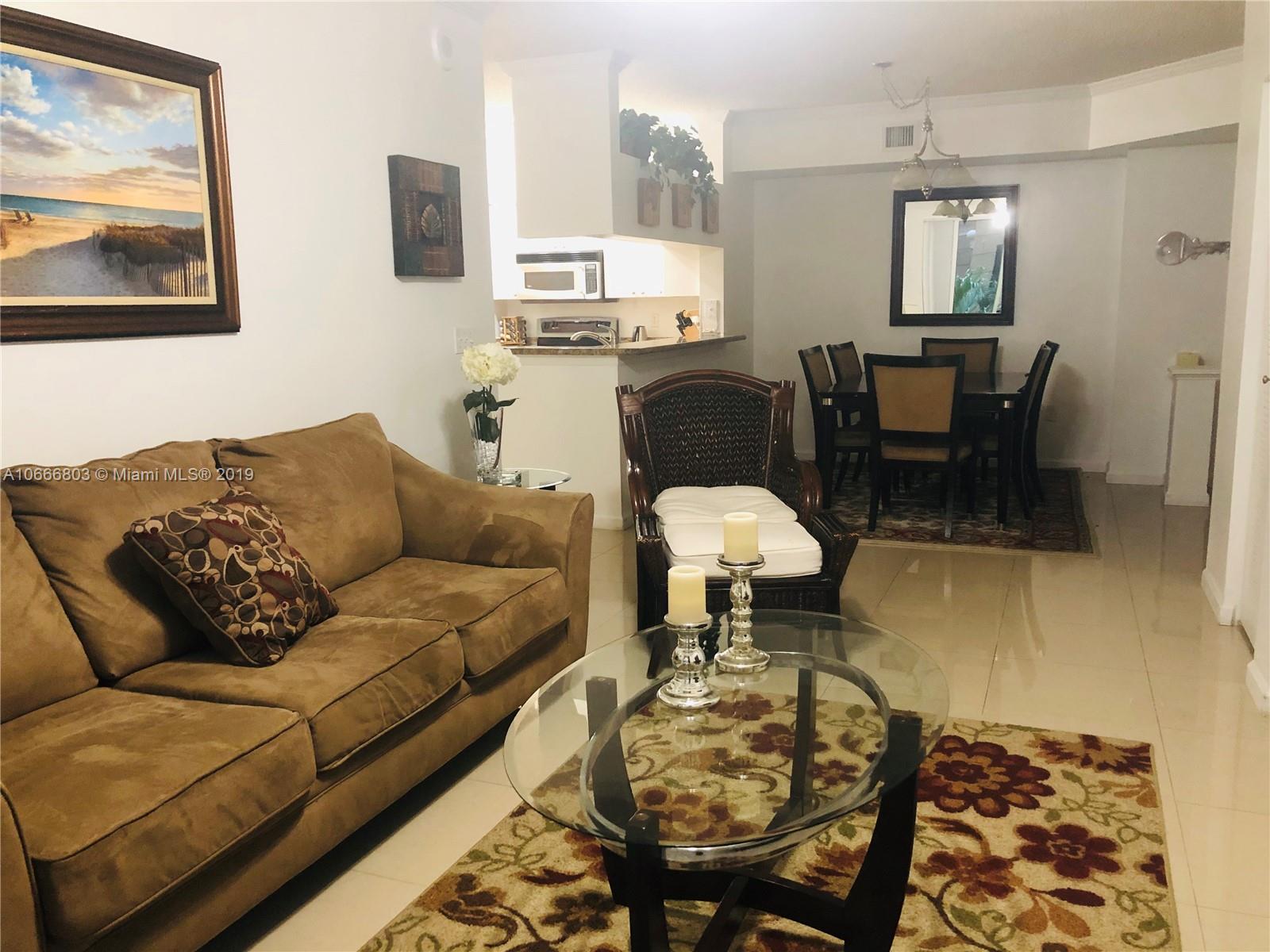 17100 North Bay Road, Unit 1212 Sunny Isles Beach, FL 33160 - Photo 3 of 24 a living room with furniture and wooden floor