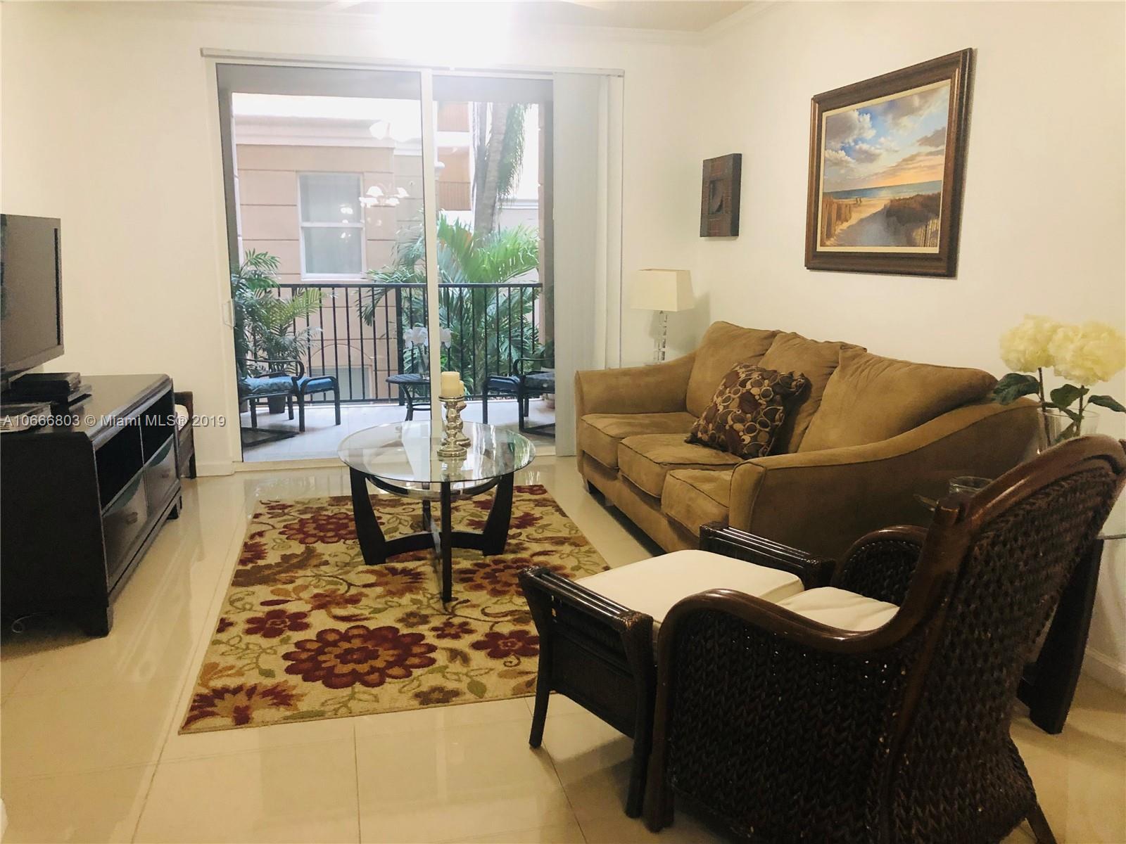17100 North Bay Road, Unit 1212 Sunny Isles Beach, FL 33160 - Photo 4 of 24 a living room with furniture and a flat screen tv