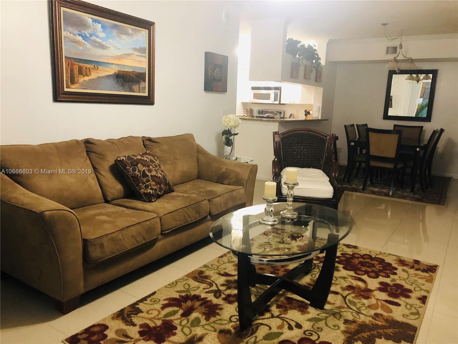 17100 North Bay Road, Unit 1212 Sunny Isles Beach, FL 33160 - Photo 6 of 24 a living room with furniture and wooden floor