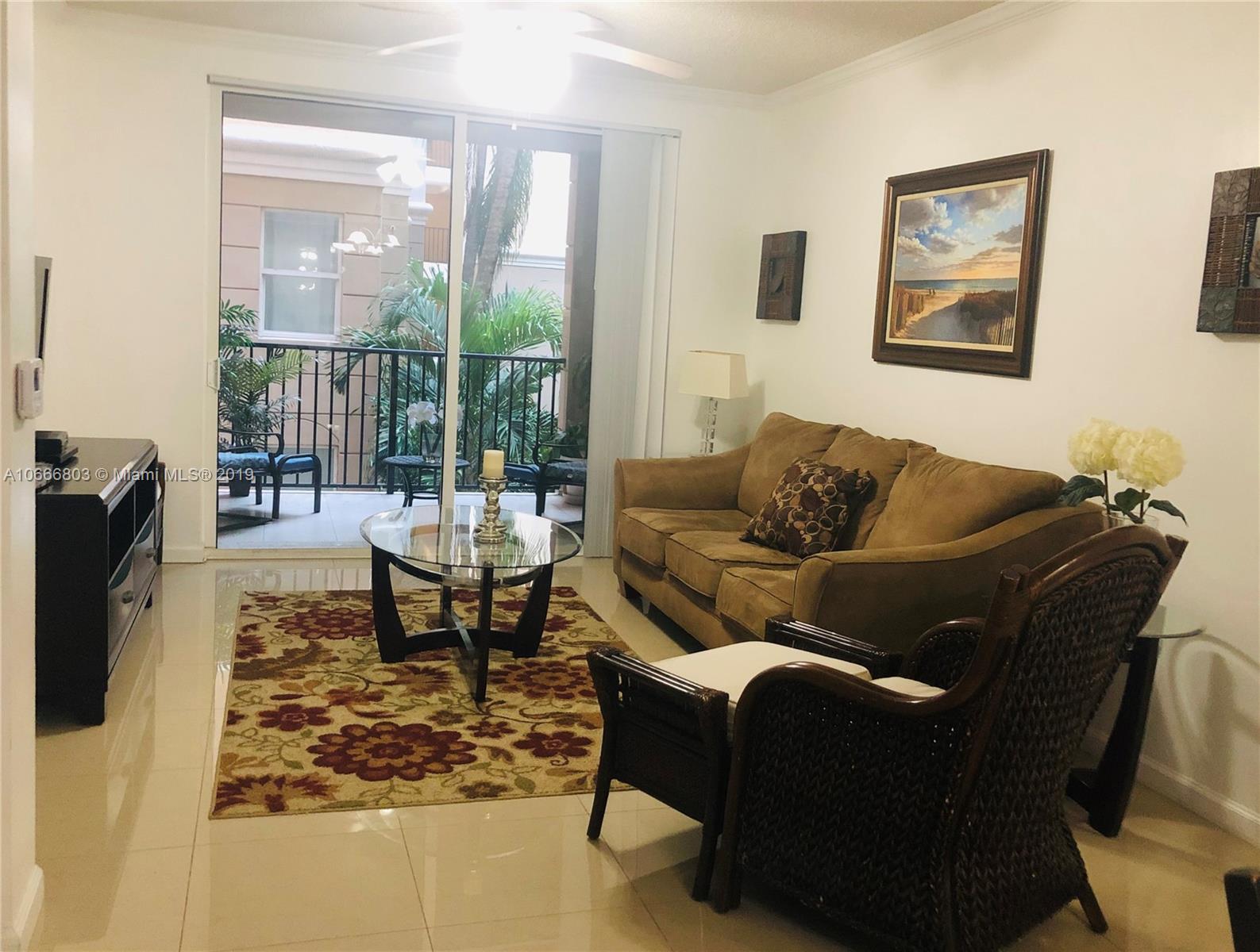 17100 North Bay Road, Unit 1212 Sunny Isles Beach, FL 33160 - Photo 8 of 24 a living room with furniture and a floor to ceiling window