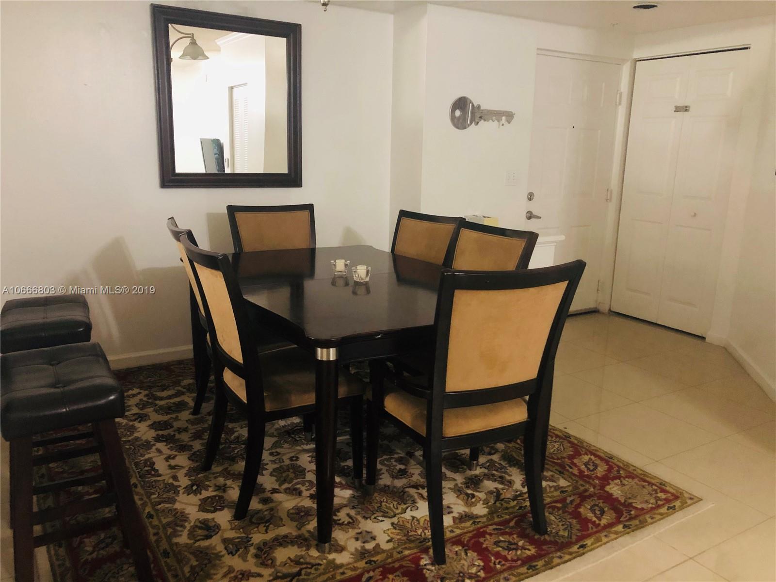17100 North Bay Road, Unit 1212 Sunny Isles Beach, FL 33160 - Photo 9 of 24 a view of a dining room with furniture