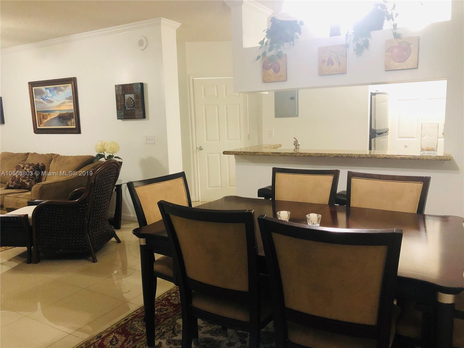 17100 North Bay Road, Unit 1212 Sunny Isles Beach, FL 33160 - Photo 10 of 24 a view of a dining room with furniture and wooden floor