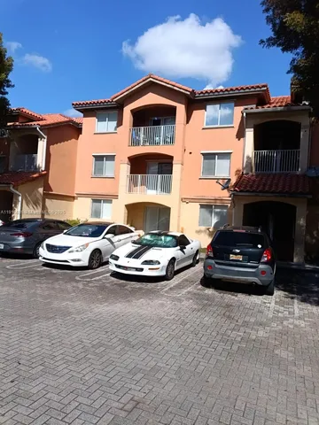 a view of a car parked in front of a brick house