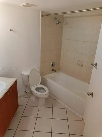 a white toilet sitting next to a bath tub