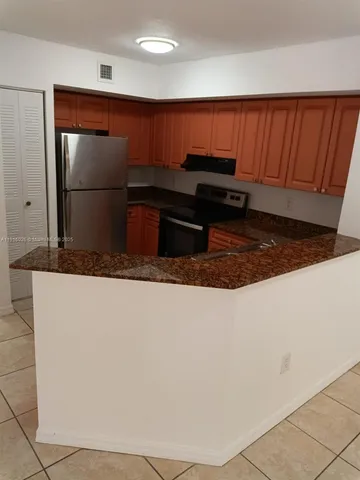 a kitchen with a refrigerator and a sink