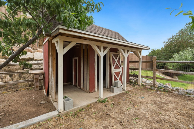 672 Perry Hollow Drive Mapleton, UT 84664 - Photo 102 of 106 Red-sided outdoor structure with a shingle roof and a covered porch area