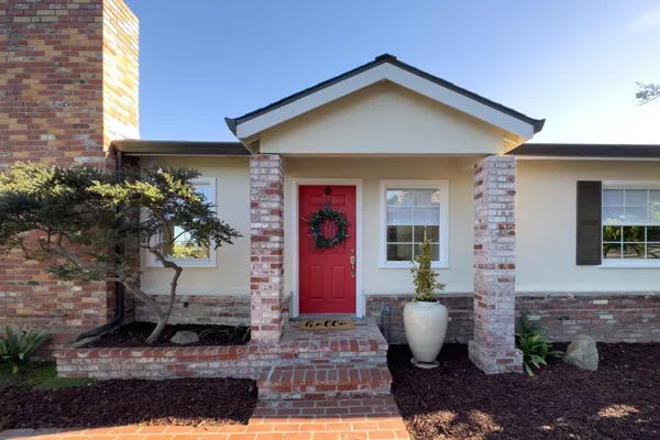 a front view of a house with garden