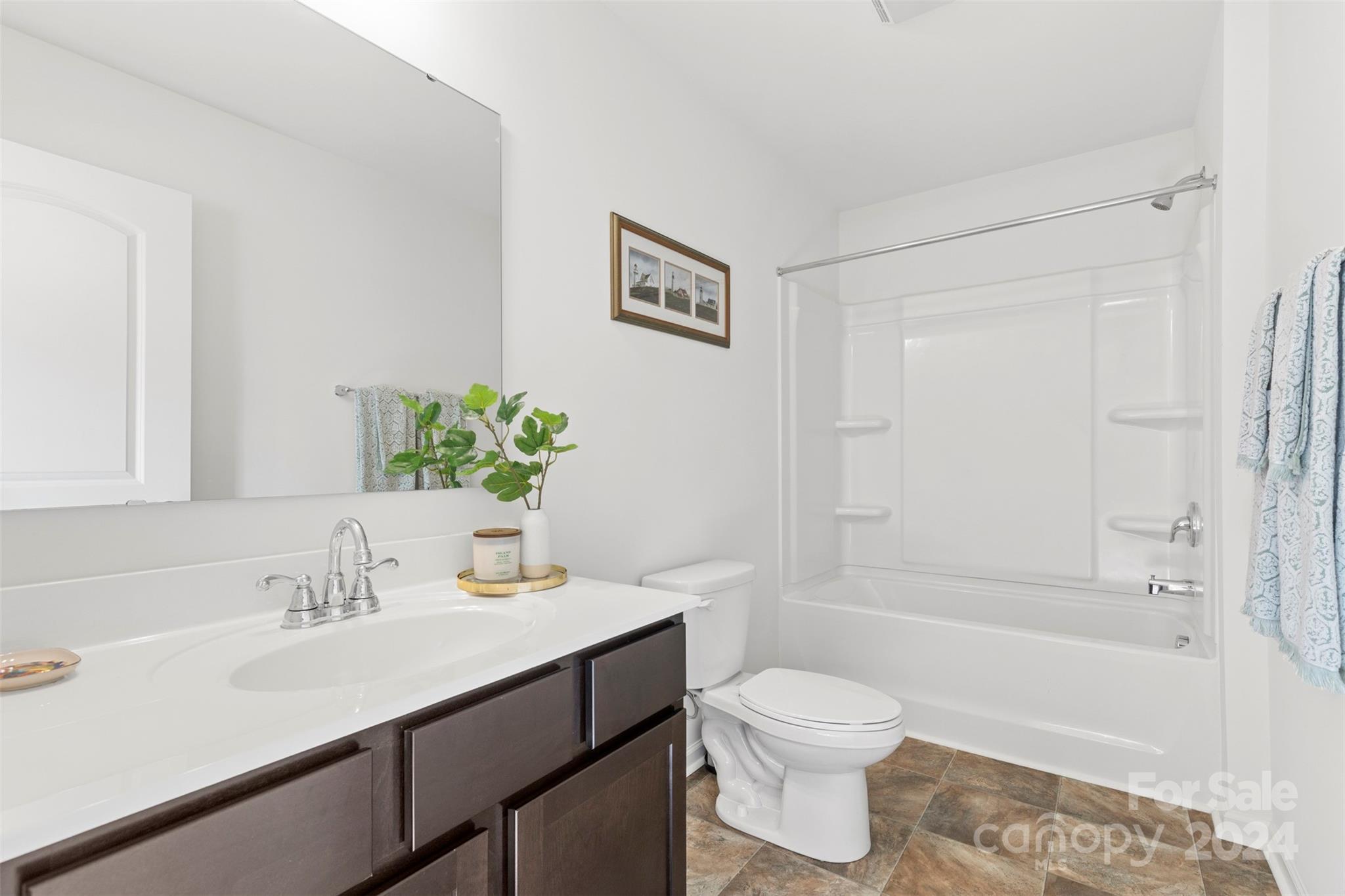 1015 Cherry Bark Place Landis, NC 28088 - Photo 16 of 24 a bathroom with a sink a toilet and shower