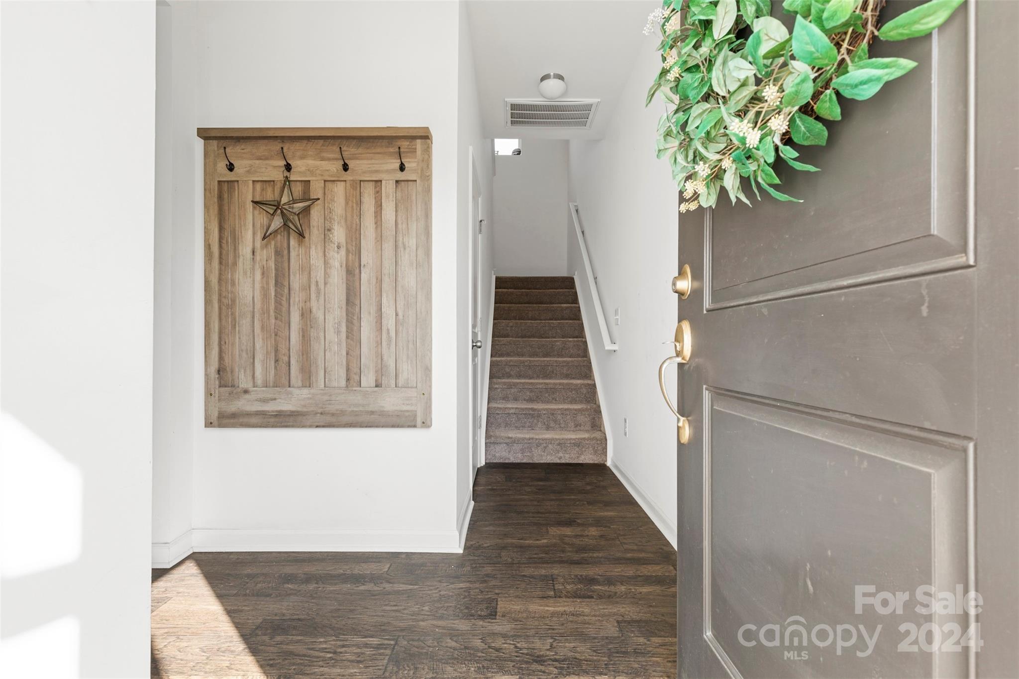 1015 Cherry Bark Place Landis, NC 28088 - Photo 4 of 24 a view of a hallway with wooden floor and a potted plant
