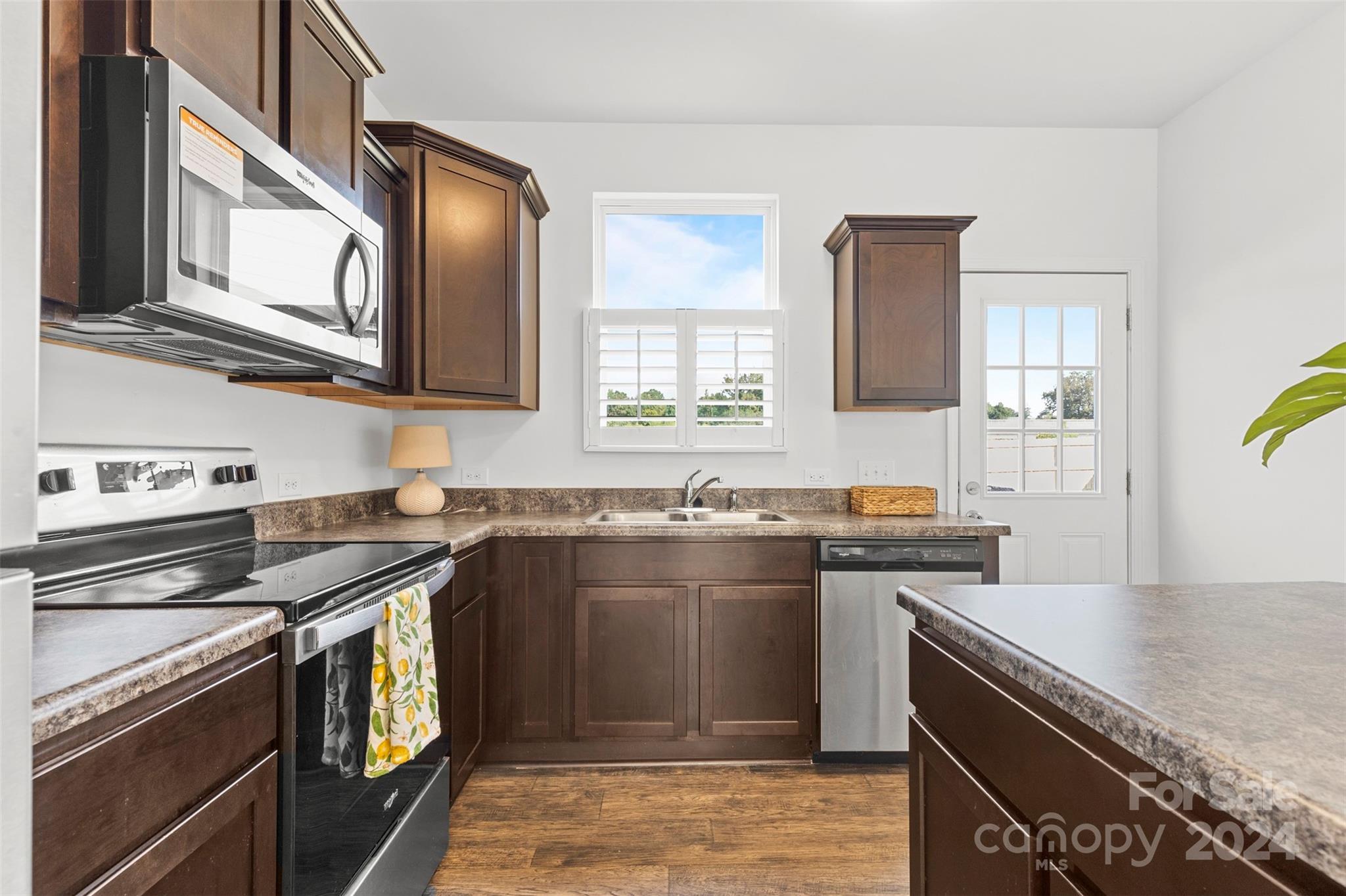 1015 Cherry Bark Place Landis, NC 28088 - Photo 6 of 24 a kitchen with stainless steel appliances granite countertop a stove a sink and a microwave