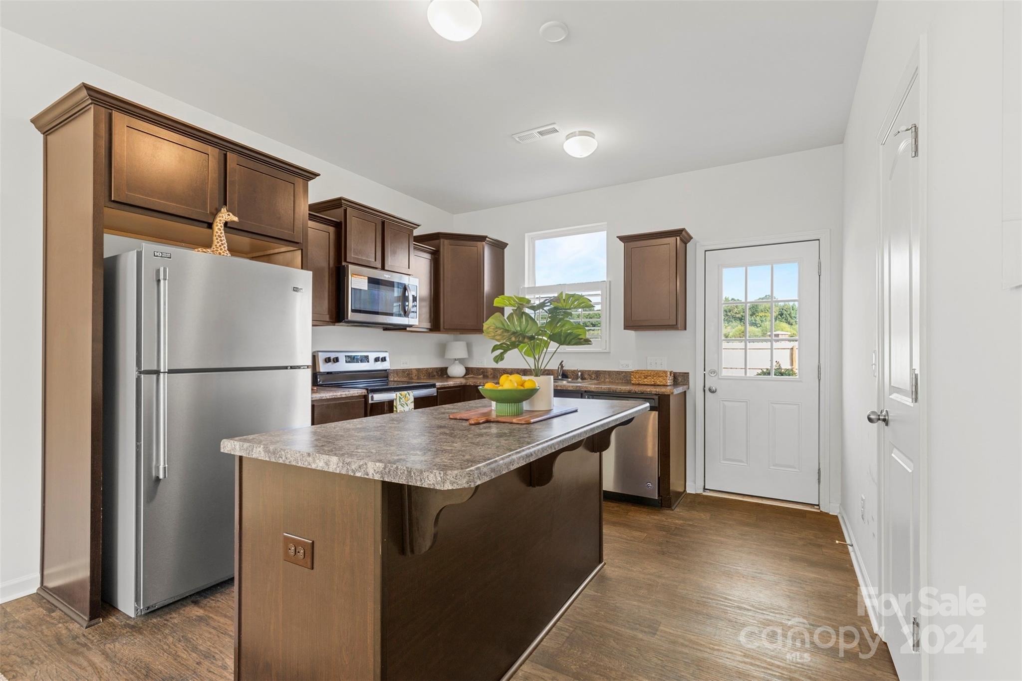 1015 Cherry Bark Place Landis, NC 28088 - Photo 7 of 24 a kitchen with stainless steel appliances granite countertop a refrigerator a sink a stove and a refrigerator