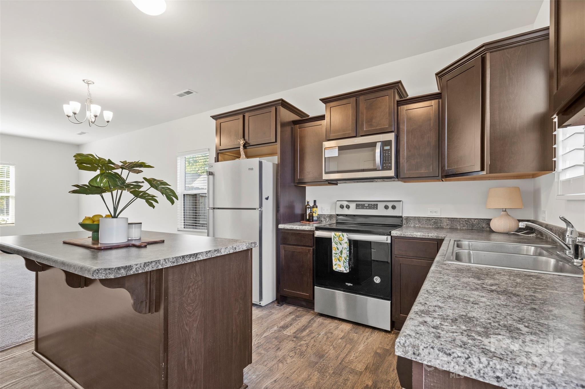 1015 Cherry Bark Place Landis, NC 28088 - Photo 8 of 24 a kitchen with stainless steel appliances granite countertop a sink stove and refrigerator