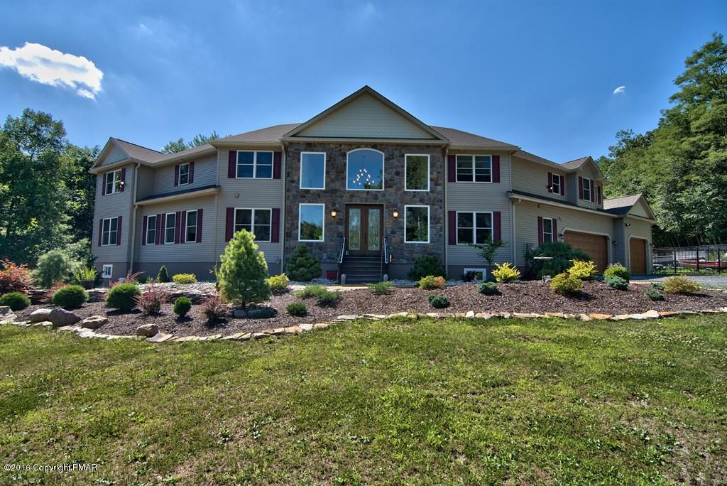 271 Williams Road Cresco, PA 18326 - Photo 1 of 46 a front view of a house with sitting area and fire pit