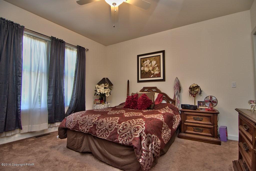 271 Williams Road Cresco, PA 18326 - Photo 17 of 46 a bed sitting in a bedroom next to a window