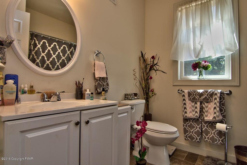 271 Williams Road Cresco, PA 18326 - Photo 19 of 46 a bathroom with a toilet sink and mirror