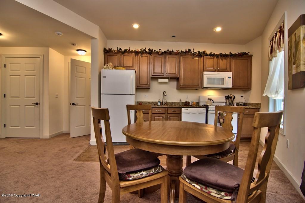 271 Williams Road Cresco, PA 18326 - Photo 20 of 46 a kitchen with a dining table chairs and refrigerator