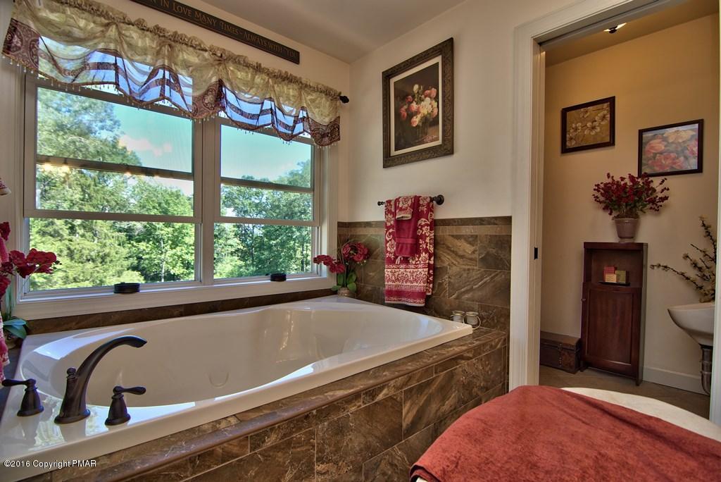 271 Williams Road Cresco, PA 18326 - Photo 21 of 46 a bathroom with a bathtub and a window
