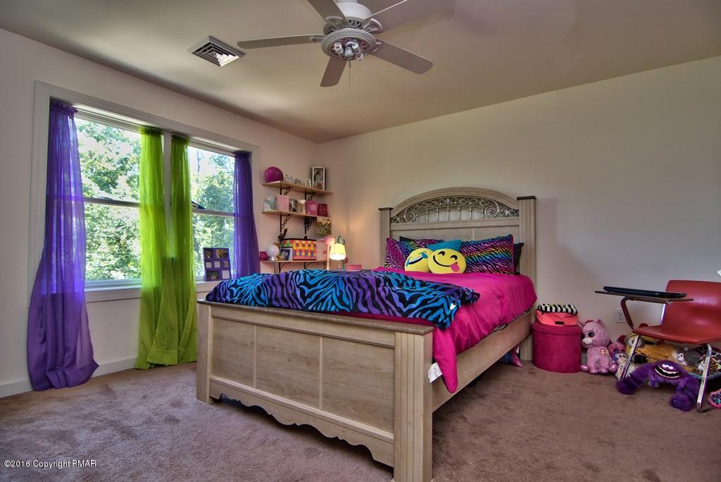 271 Williams Road Cresco, PA 18326 - Photo 23 of 46 a bedroom with a bed and a chandelier