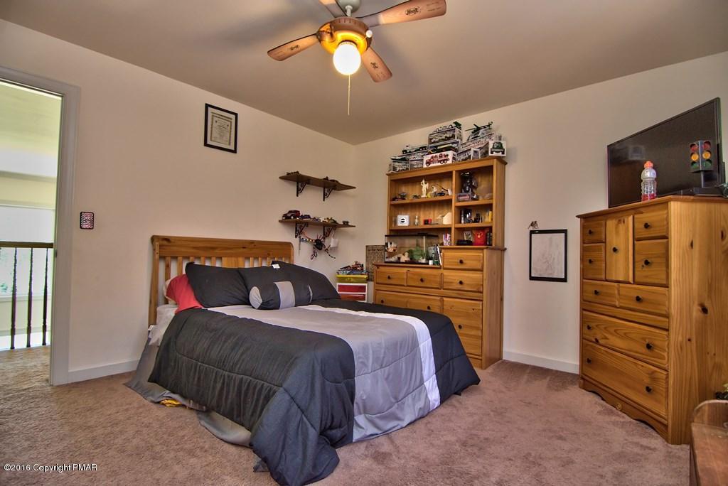 271 Williams Road Cresco, PA 18326 - Photo 28 of 46 a bedroom with a bed and a walk in closet