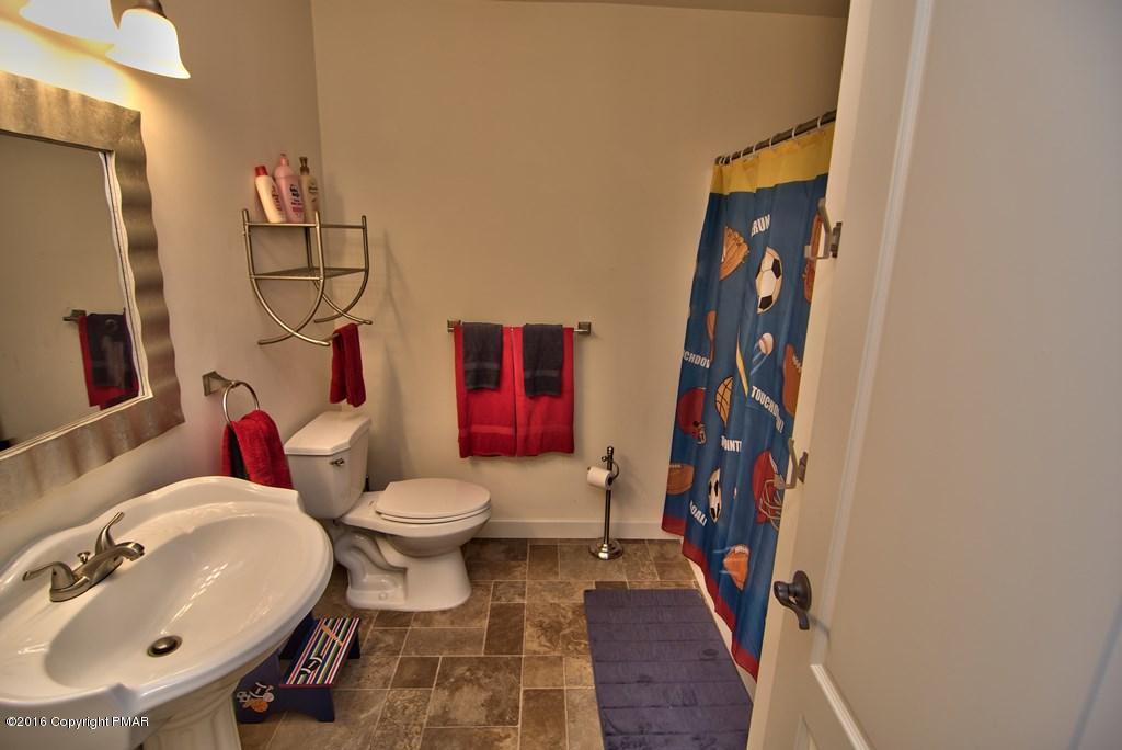 271 Williams Road Cresco, PA 18326 - Photo 29 of 46 a bathroom with a toilet sink and mirror